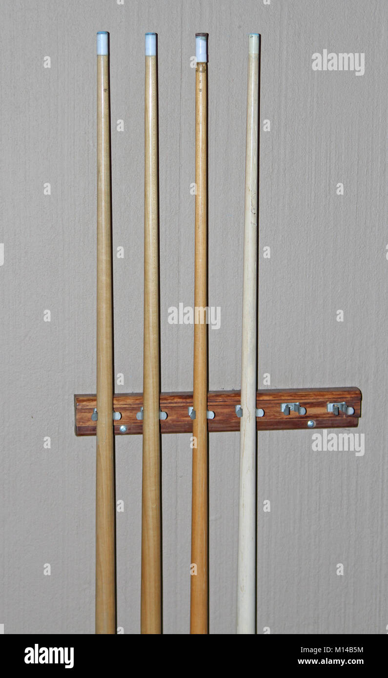 Four pool cues on wall mounted pool cue rack in a Protea Hotel Zebula Lodge, Waterberg Lodge, Bela-Bela, Limpopo Province, South Africa. Stock Photo