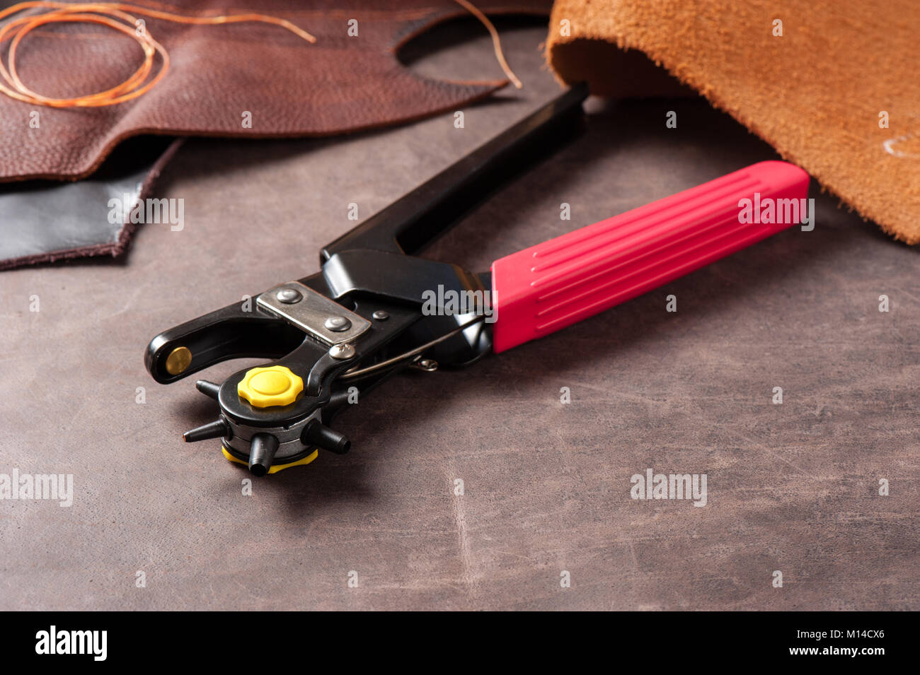 The rotary leather punch for hand stitching leather Stock Photo Alamy