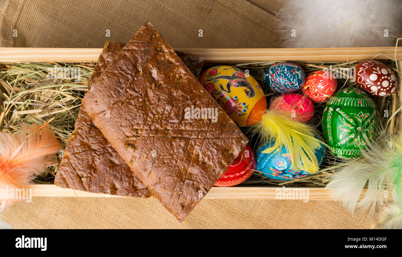 easter colored eggs and feathers on a wooden background Stock Photo - Alamy