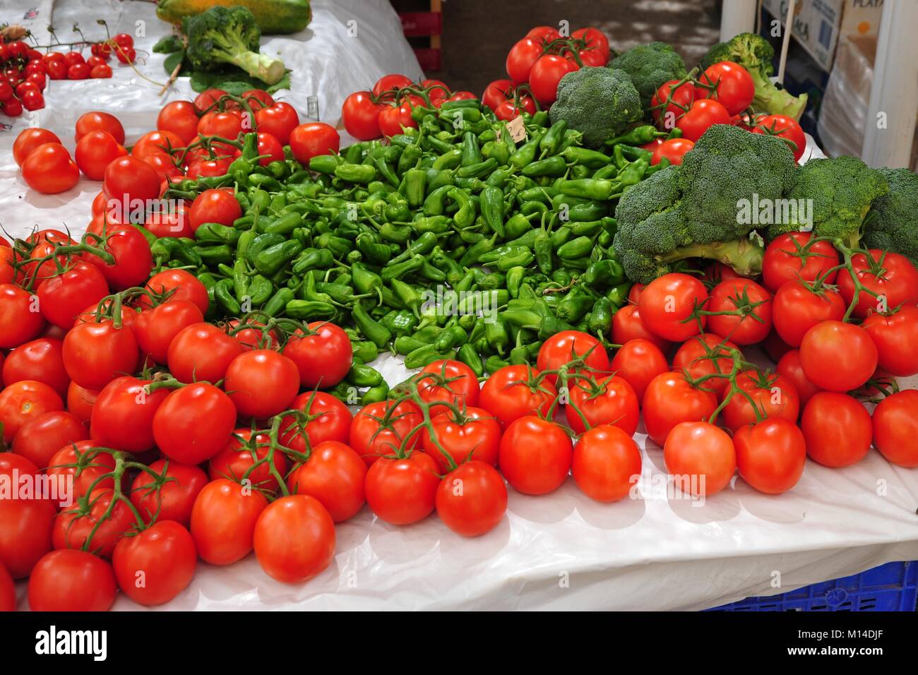 delicious arrangement of tomatoes and chillies on a Mediterranean market Stock Photo