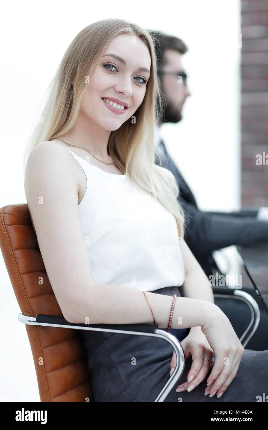 portrait of a young business woman sitting at a desk in the office ...