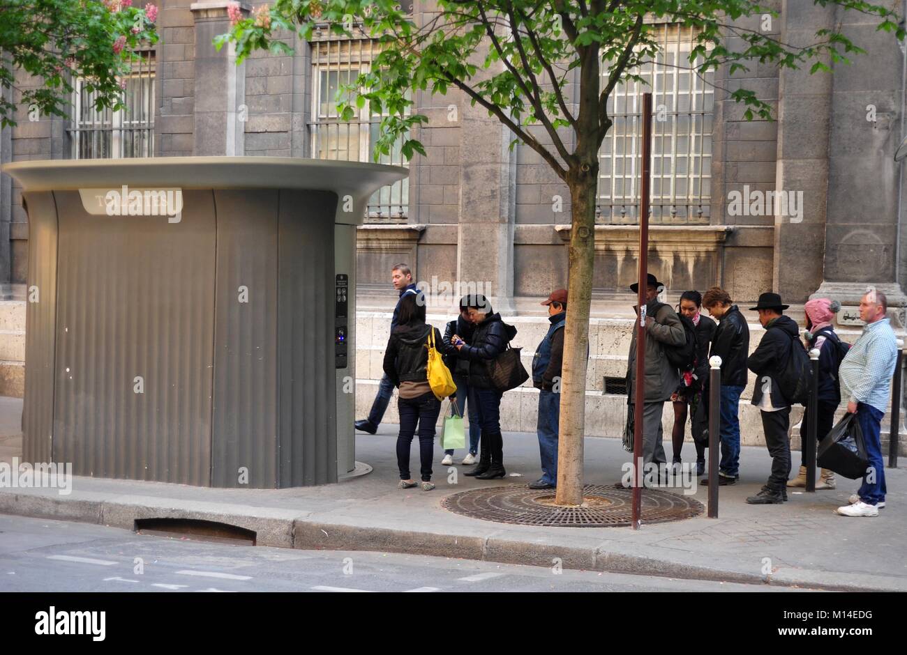 Abnormal long queue in front of an public restroom calls for patience Stock Photo