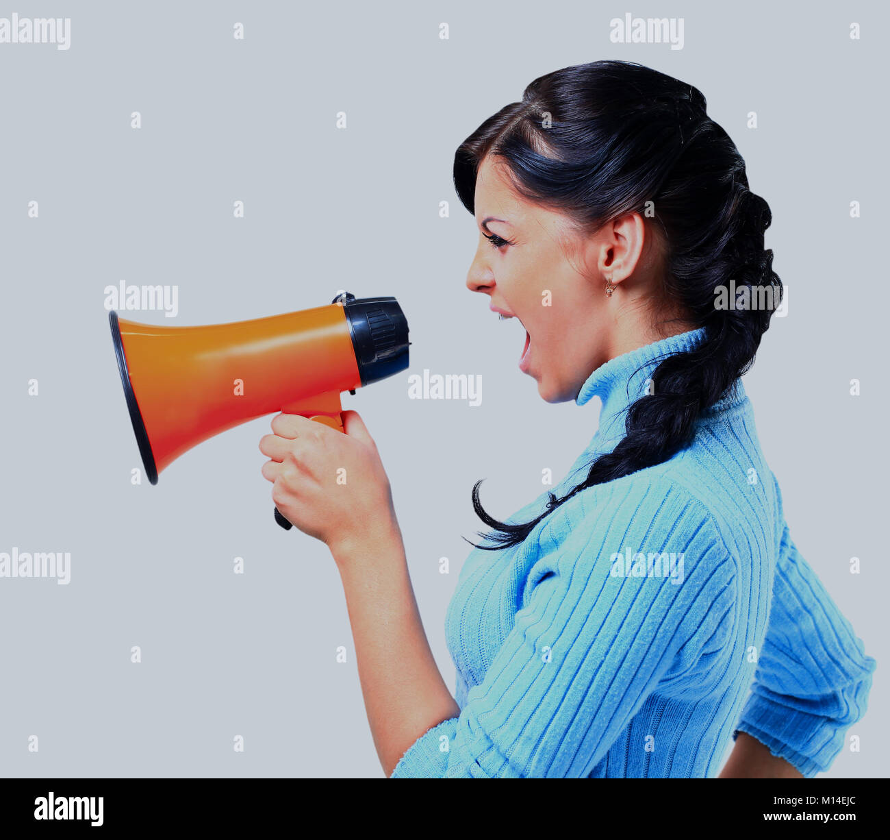 young woman speaking through megaphone Stock Photo Alamy