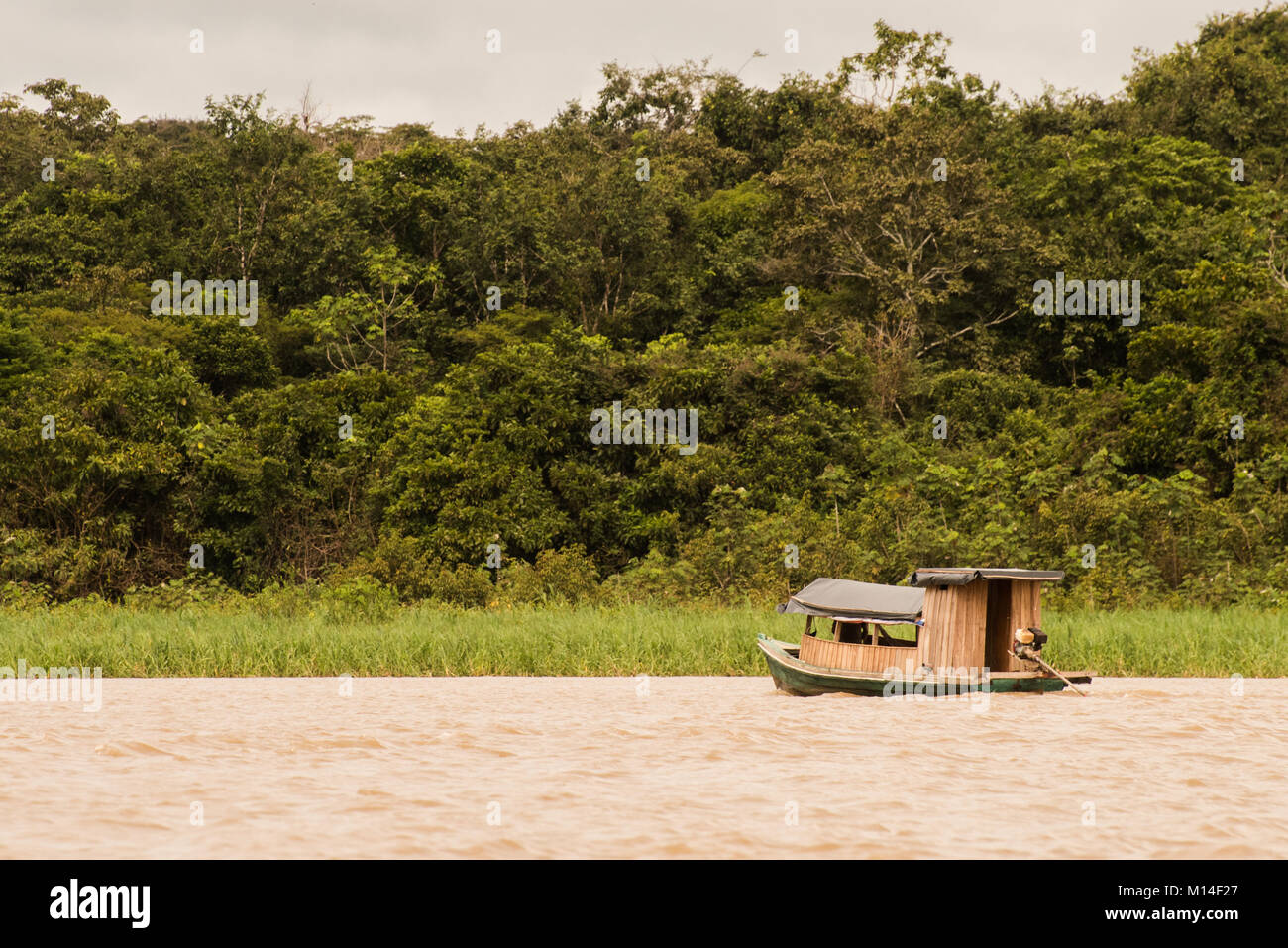 A boat traveling down the Amazon river Stock Photo Alamy