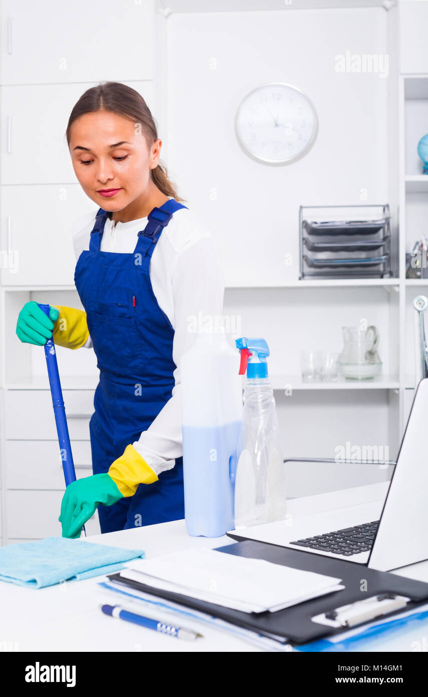 portrait of young female cleaner with duster at office Stock Photo - Alamy
