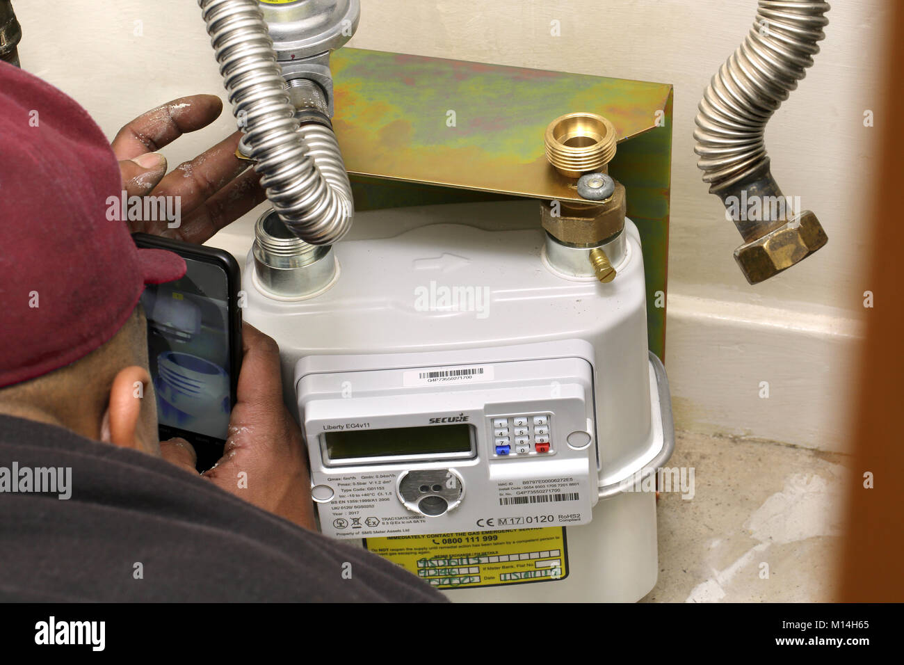Unidentified installer fitting a new gas 'smart meter'. Stock Photo