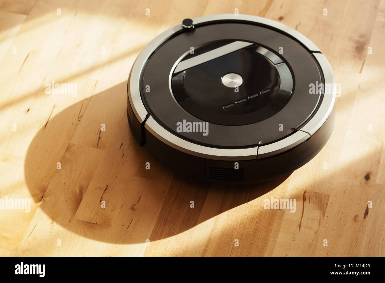 robotic vacuum cleaner on laminate wood floor smart cleaning technology Stock Photo Alamy