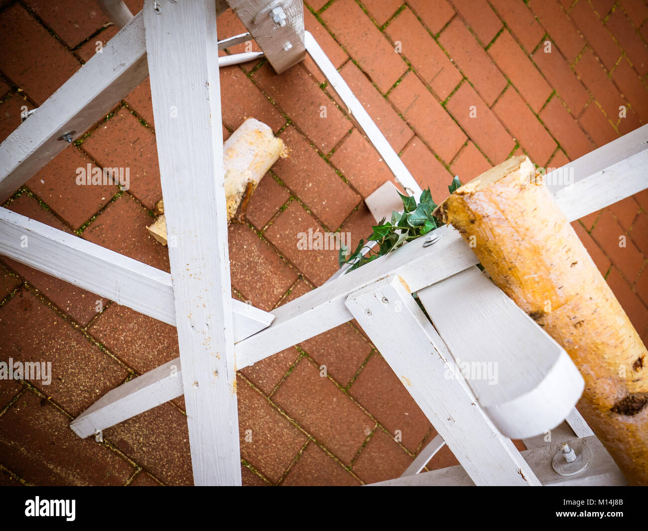 the sawed log after the wedding on the sawhorse with the saw Stock Photo