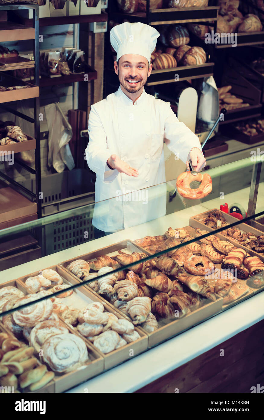 Bearded male baker showing assortment of bakery Stock Photo Alamy