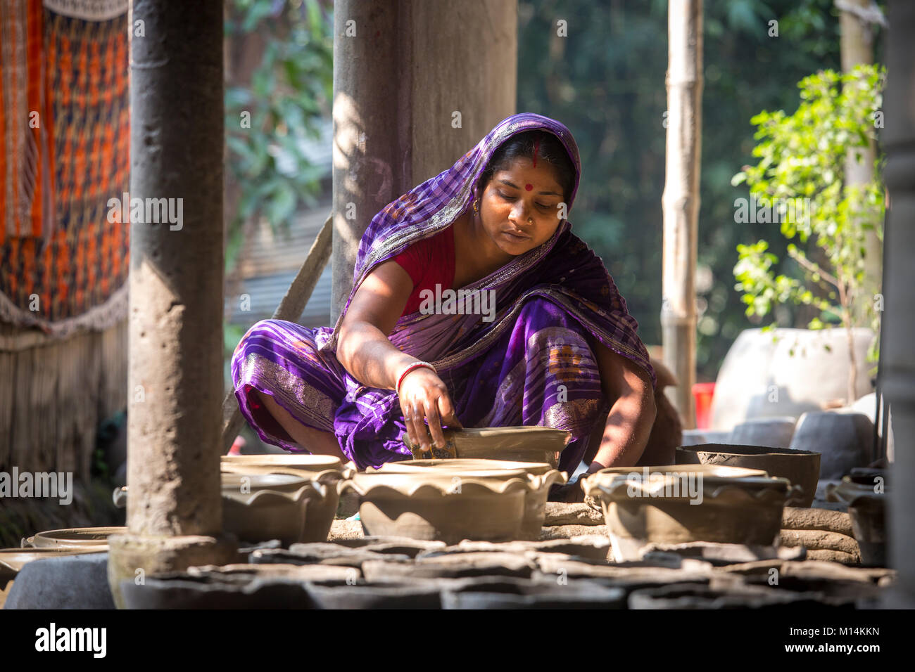 Kobita Rani Pal shapes a pottery at Iswardi, Bangladesh. Stock Photo