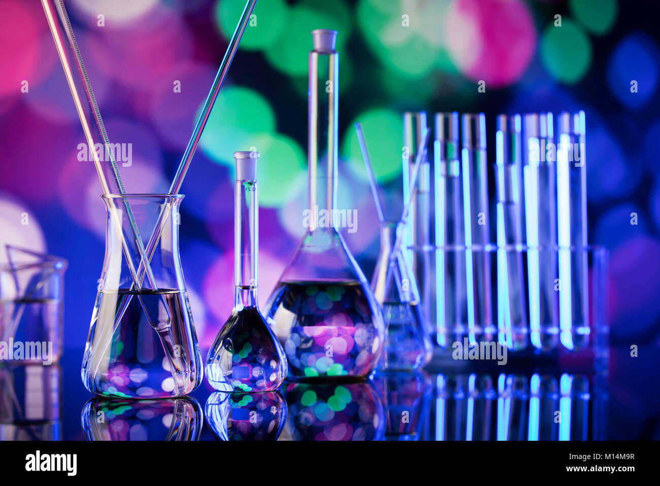 Science experiment concept background. Laboratory beakers, pipette