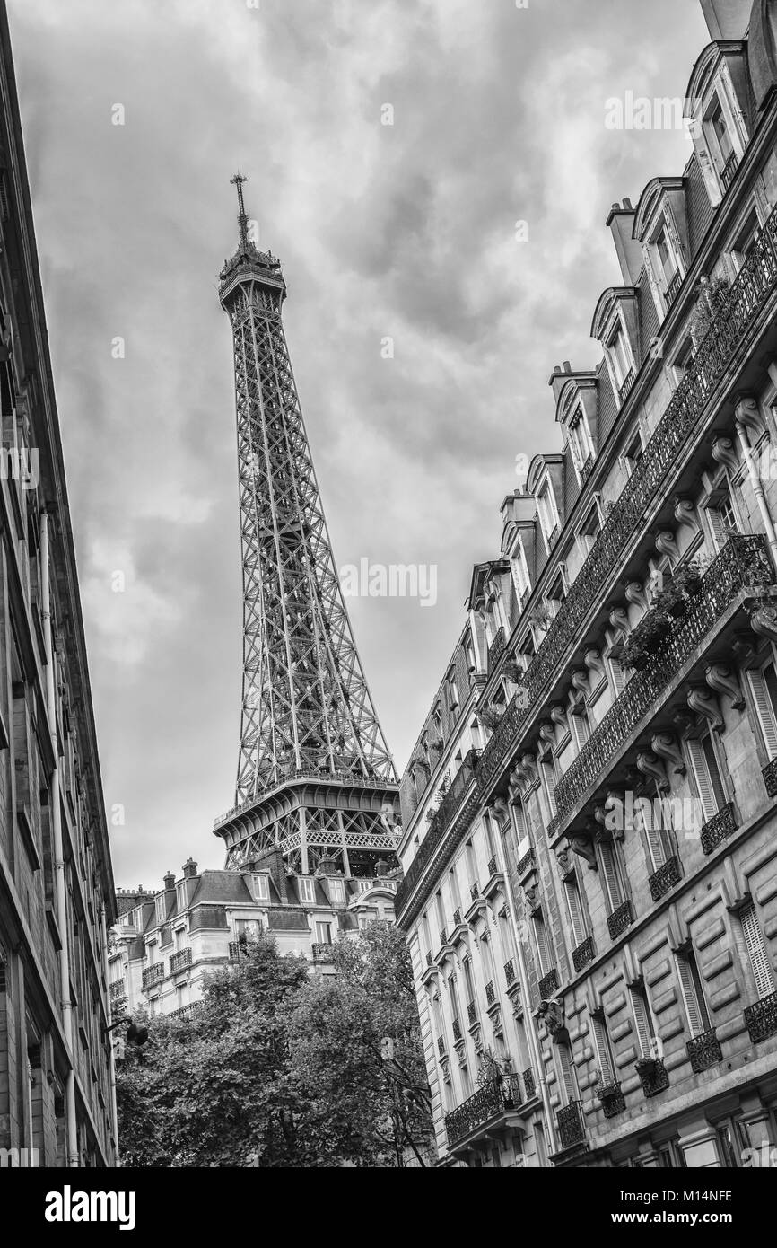 View from a small street of the oldtown in paris to the eiffel tower in black and white colors. Stock Photo