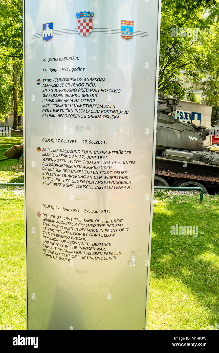 Explanation plaque explaining the history behind the 'Red Fico' monument at Osijek, Croatia. Stock Photo