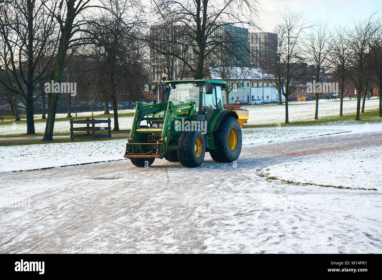 Tractor gritting the pathways in the Glasgow Green Park, Glasgow, Scotland. Stock Photo