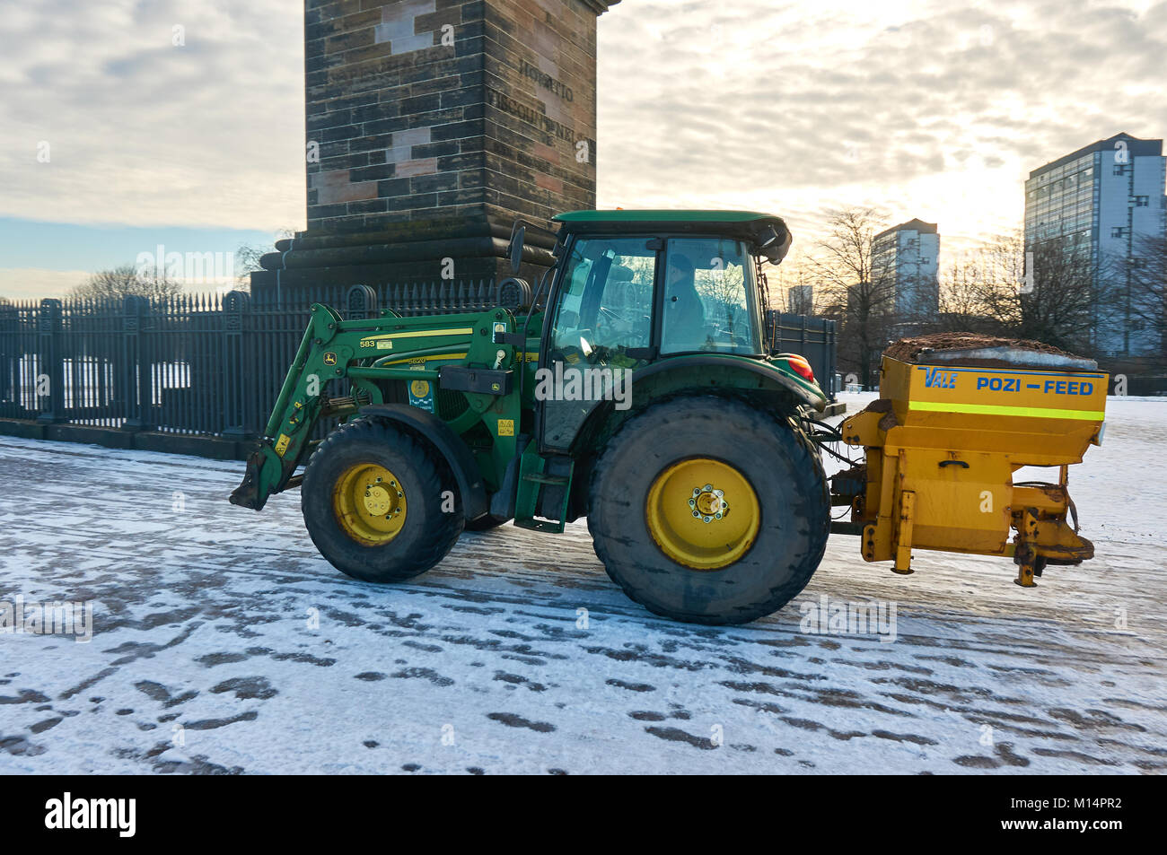 Tractor gritting the pathways in the Glasgow Green Park, Glasgow, Scotland. Stock Photo