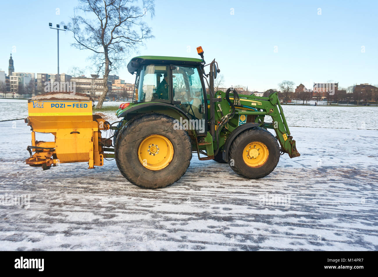 Tractor gritting the pathways in the Glasgow Green Park, Glasgow, Scotland. Stock Photo