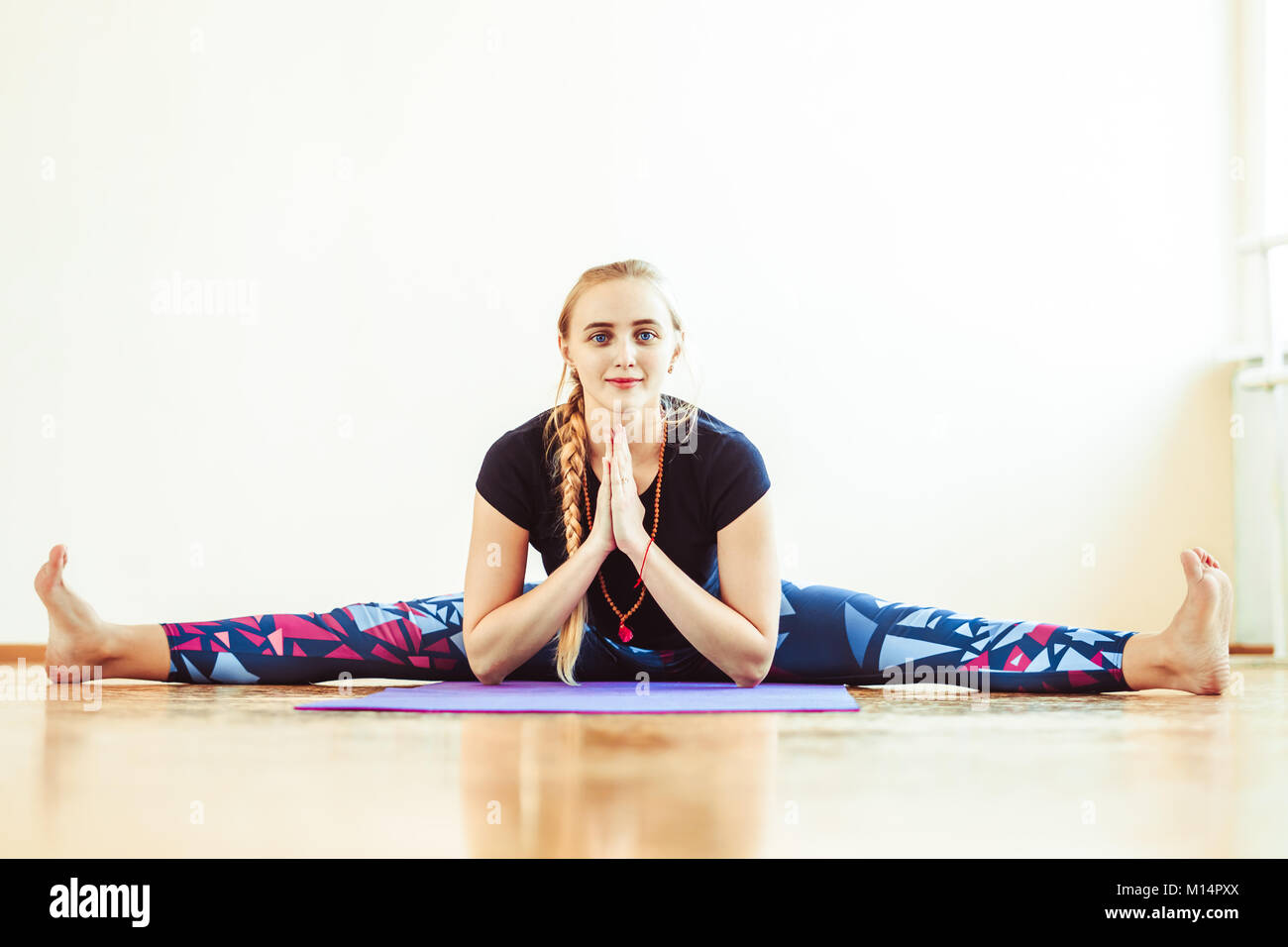 girl is doing stretching twine in a sitting position Stock Photo Alamy