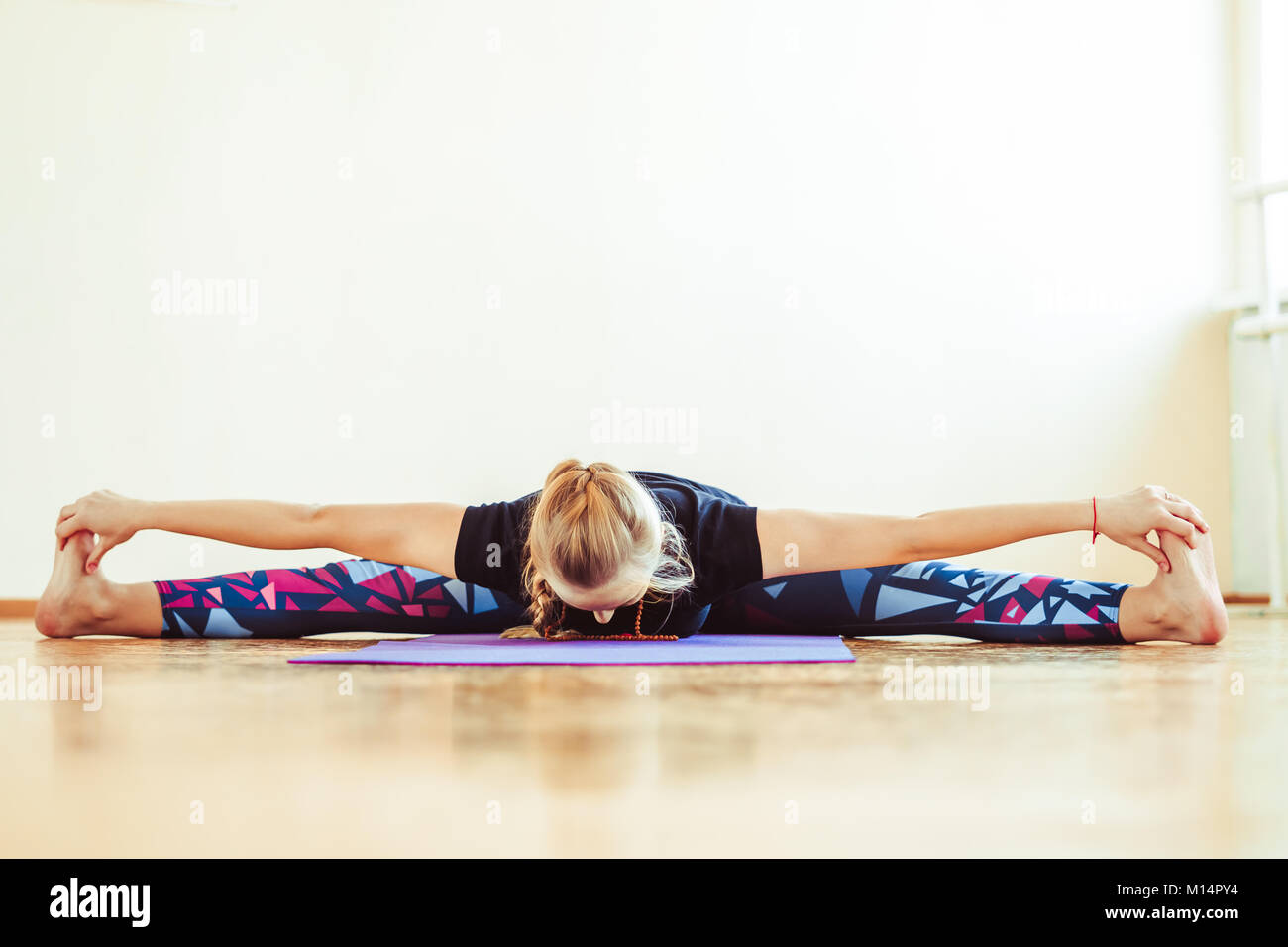 girl is doing stretching twine in a sitting position Stock Photo Alamy