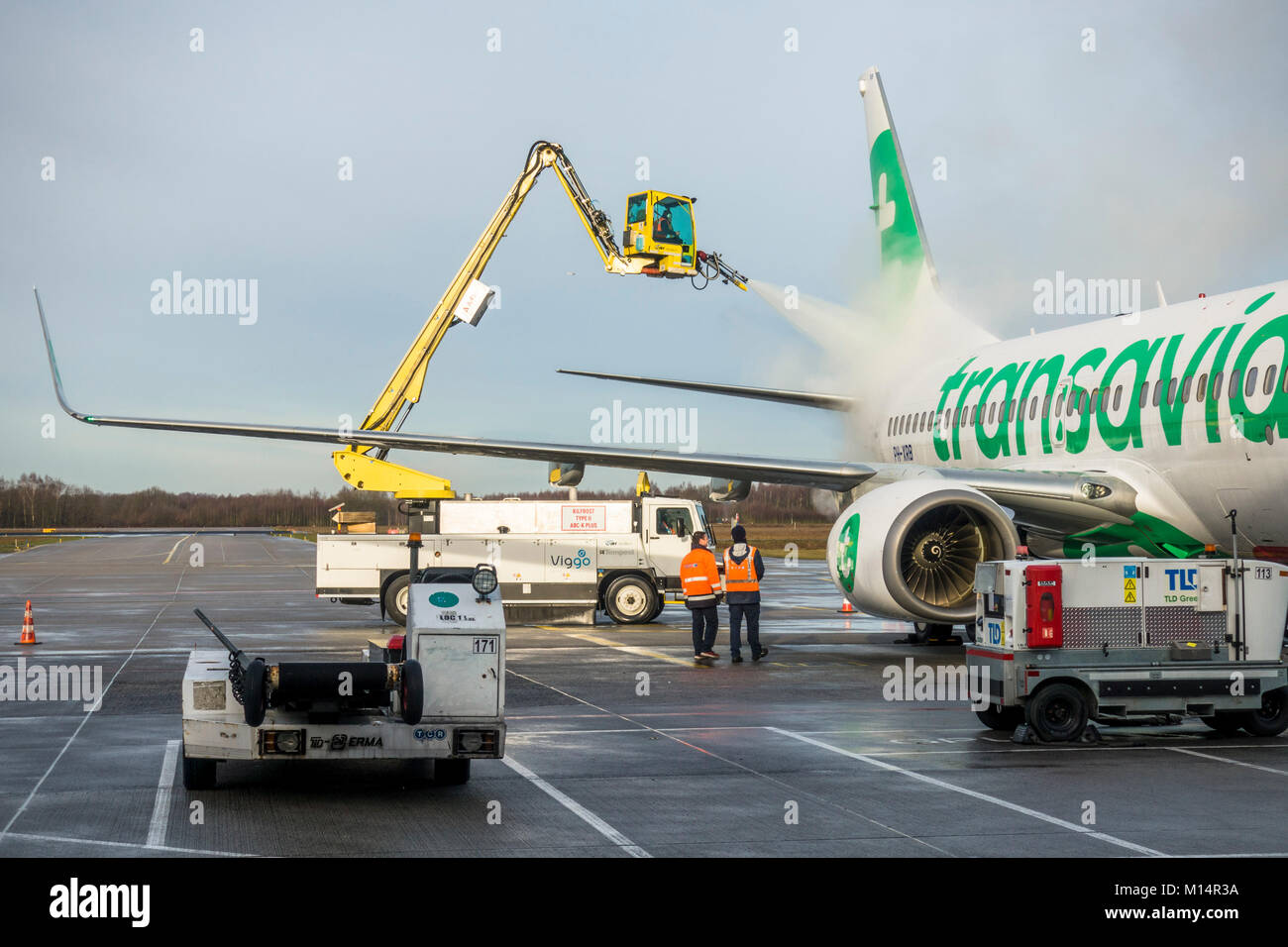 Transavia aircraft, de-icing of wings and tail, Airport Eindhoven, Netherlands. Stock Photo