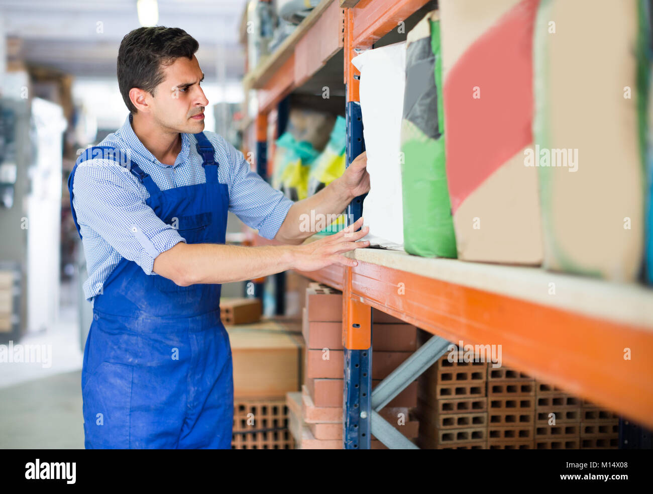 Builder is choosing cement in the building store. Stock Photo
