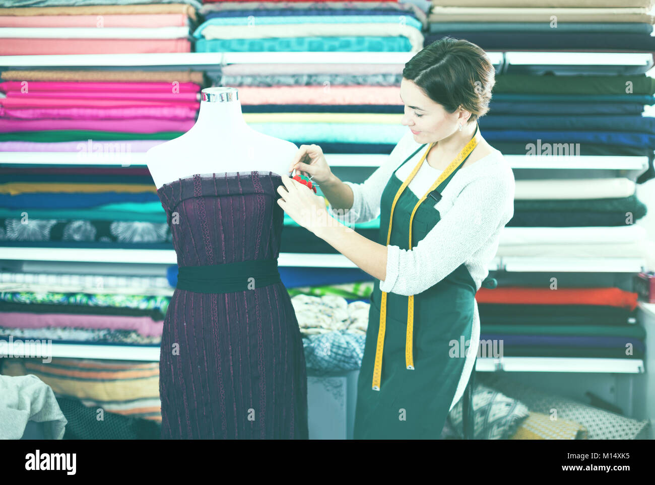 Female tailor finishing work at festive dress at studio Stock Photo - Alamy