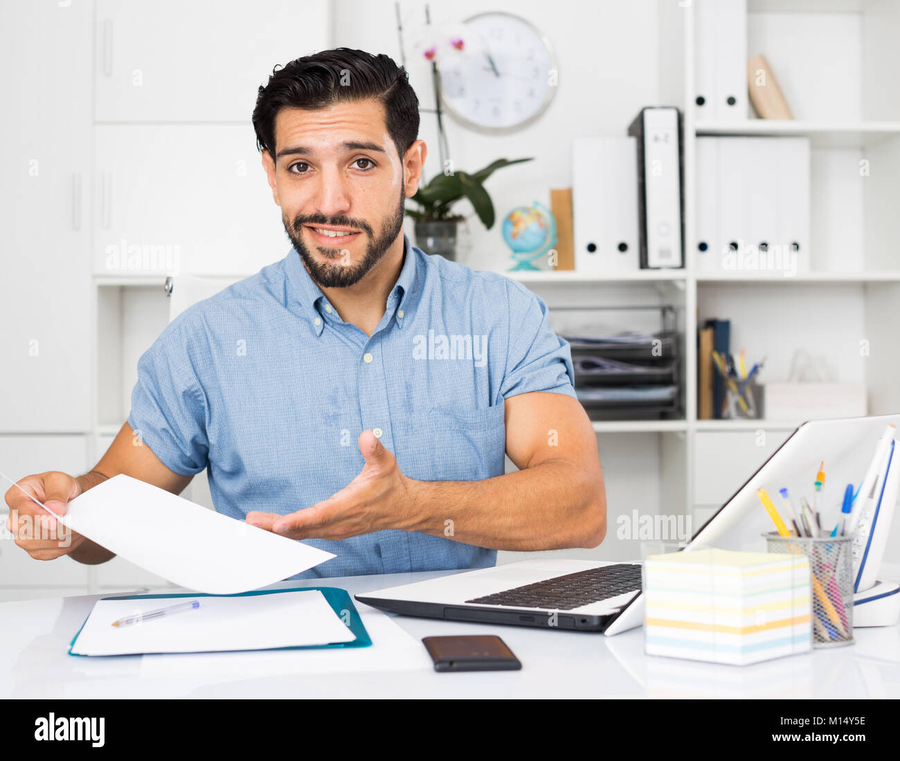 Spanish businessman is talking with partner about contract in office. Stock Photo