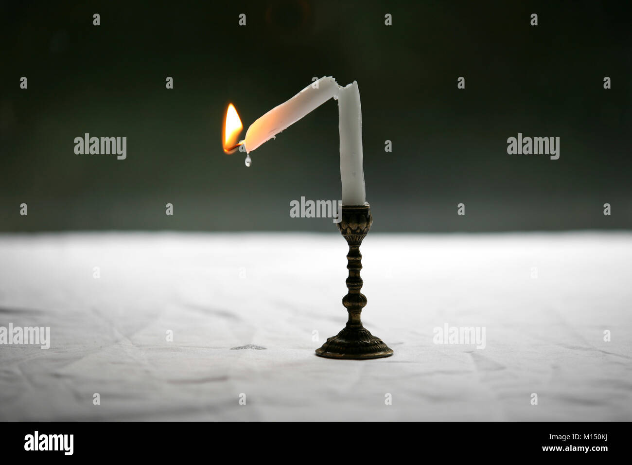 Broken candle dripping wax Stock Photo Alamy