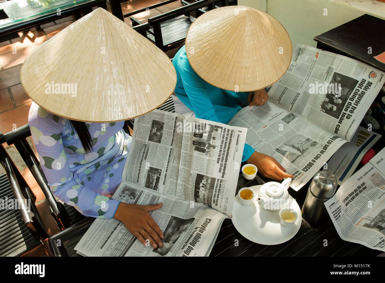 Vietnam, vietnamese ladies reading newspaper Stock Photo