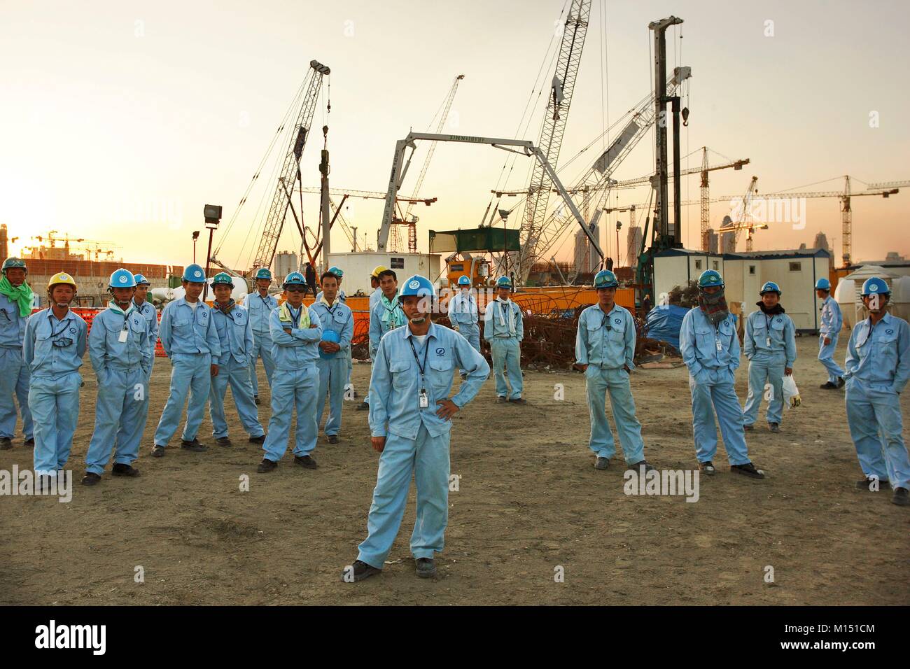 United Arab Emirates, Dubai, workers on construction site on Palm Jumeirah (2005) Stock Photo