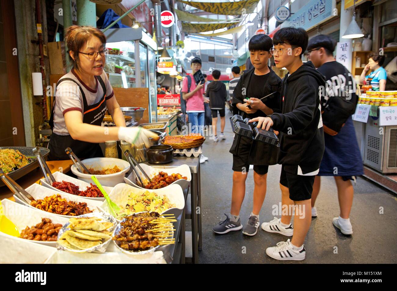South Korea, Seoul, cook serving korean dishes to schoolchildren in the