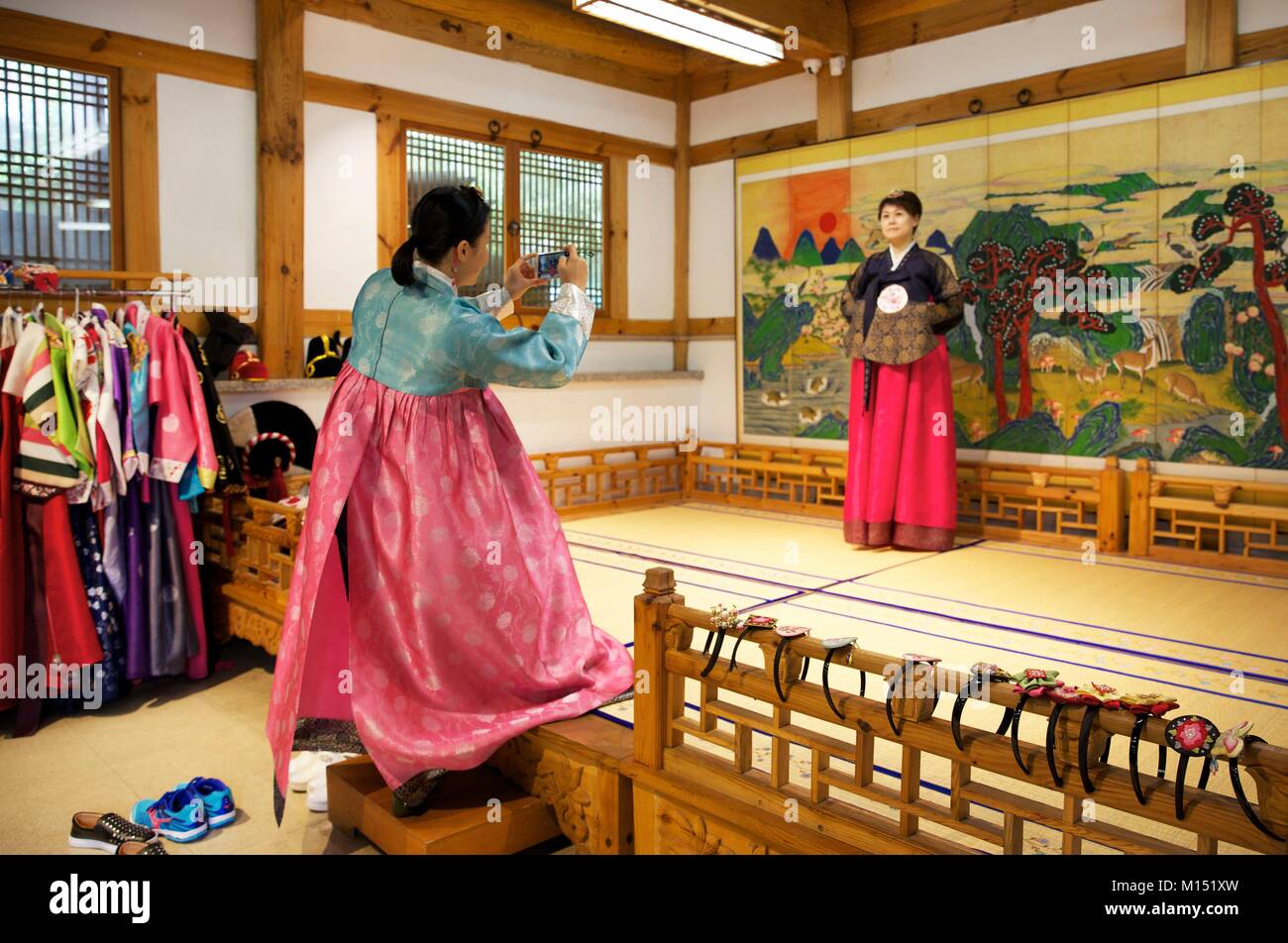 South Korea, Seoul, woman photographing her friend in a hambok rental shop, the traditional korean houtfit Stock Photo