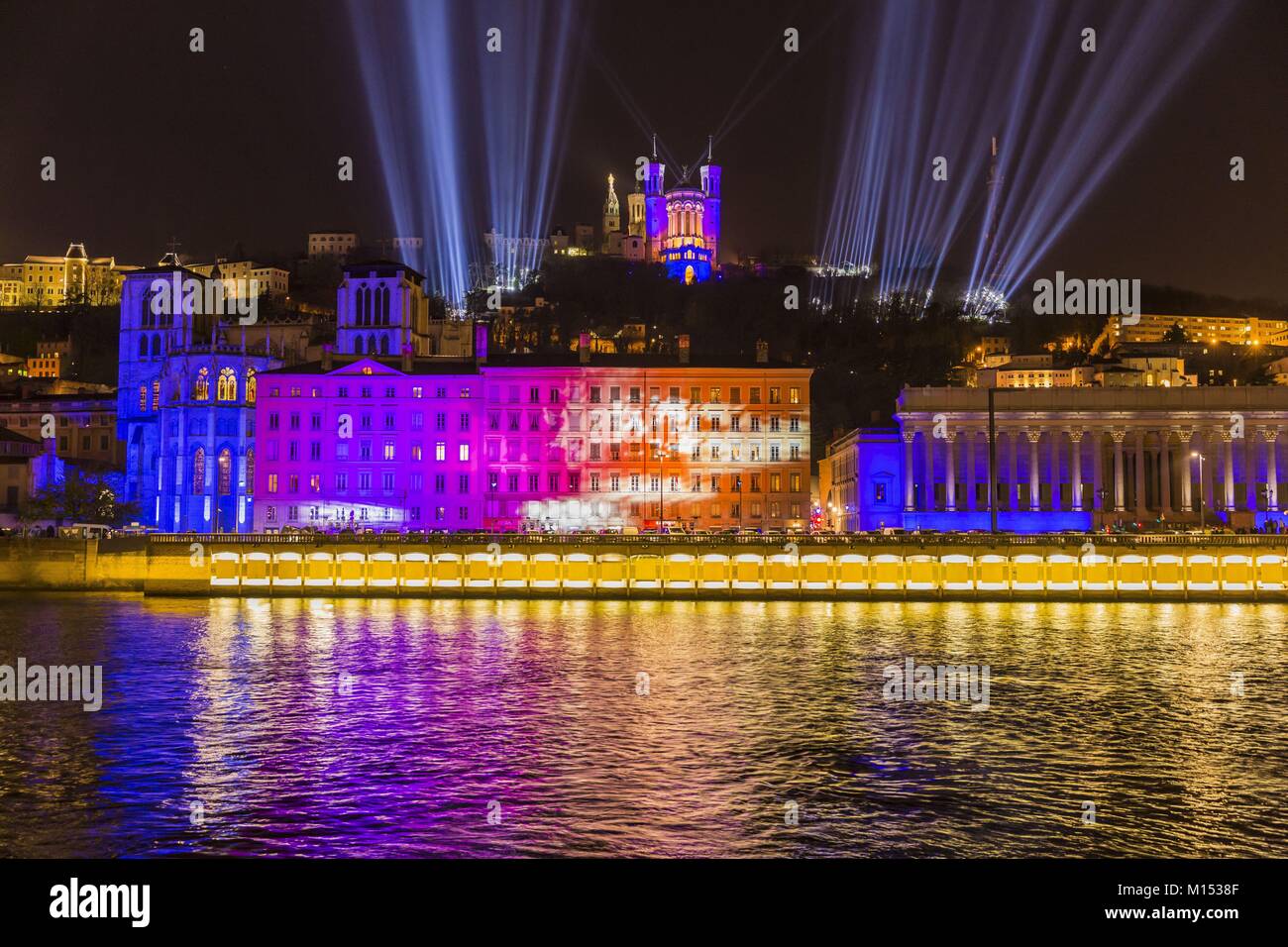 France, Rhone, Lyon, historical site listed as World Heritage by UNESCO, St Jean Cathedral, the courthouse at the edge of Saone River and Notre Dame de Fourviere Basilica during the Fete des Lumieres (Light Festival), show Time For Light of Les Orpailleurs de Lumiere Stock Photo