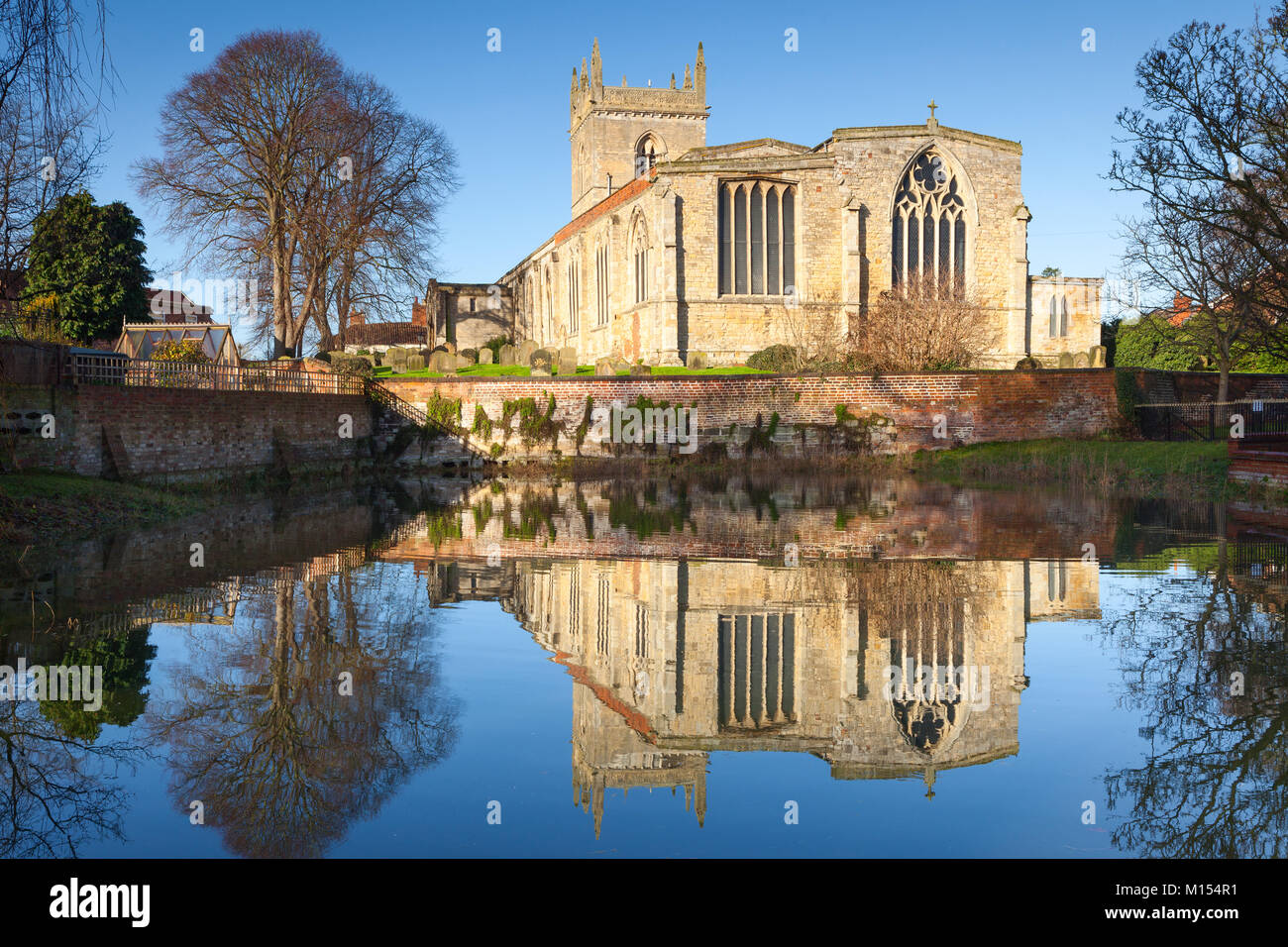 St. Mary's Church reflected in the Beck. Barton-upon-Humber, North Lincolnshire, UK. January 2018. Stock Photo