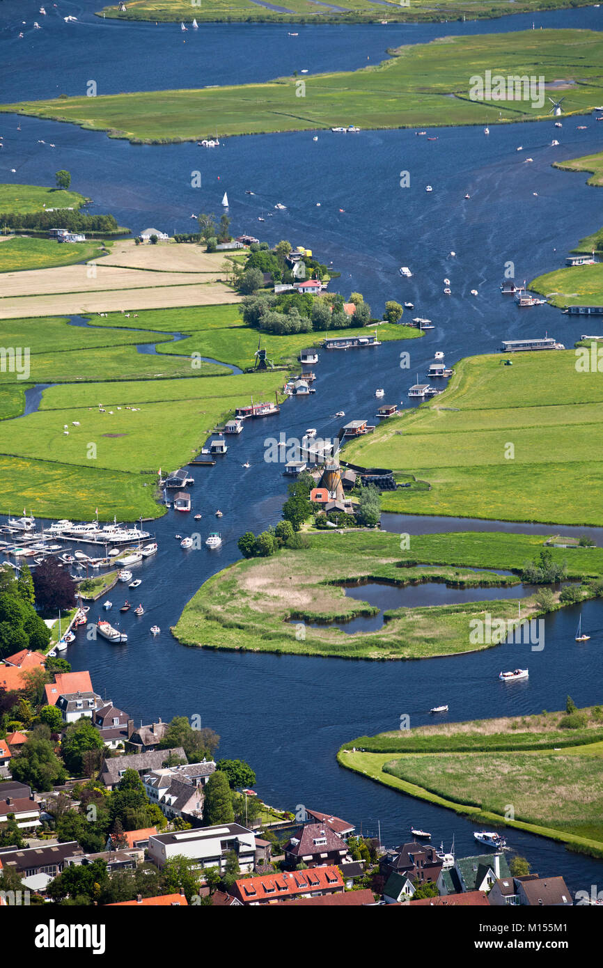 The Netherlands, Warmond, Windmill, yachts and houseboats in lakes called Kagerplassen. Aerial. Stock Photo