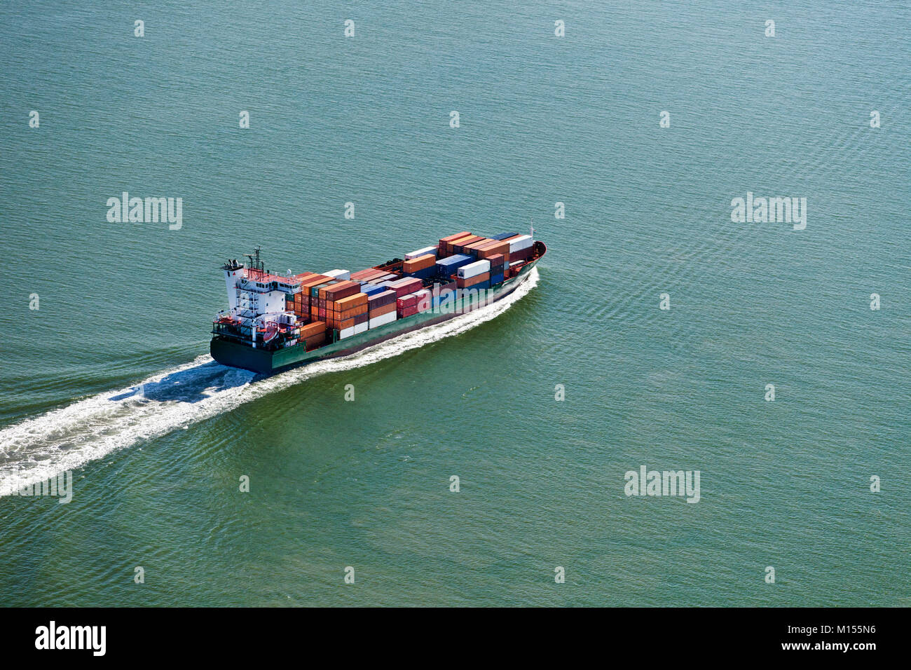 The Netherlands, Nieuw Namen. Container ship in Westerschelde river. Aerial. Stock Photo