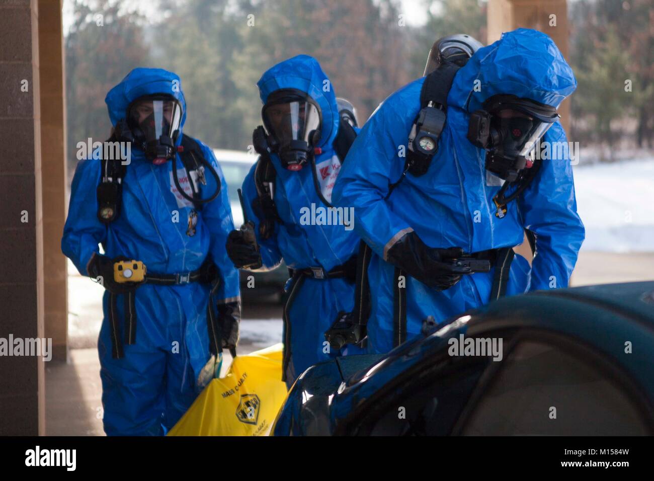 U.S. Marines with 2nd Marine Aircraft Wing search a training area for simulated chemical threats while wearing class b hazardous material suits  during Ullr Shield on Fort McCoy, Wis., Jan. 21, 2018. Ullr Shield is a training exercise designed to improve 2nd Marine Aircraft Wing's capabilities in extreme cold weather environments. (U.S. Marine Corps photo by Sgt. Joselyn Jimenez) Stock Photo