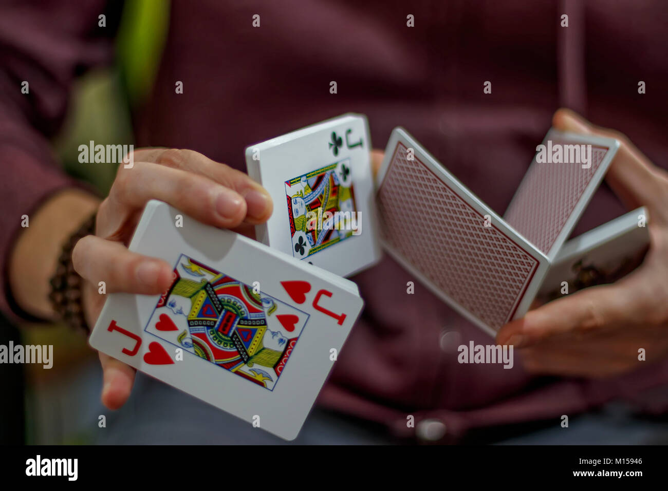 Men's hands with playing cards Stock Photo