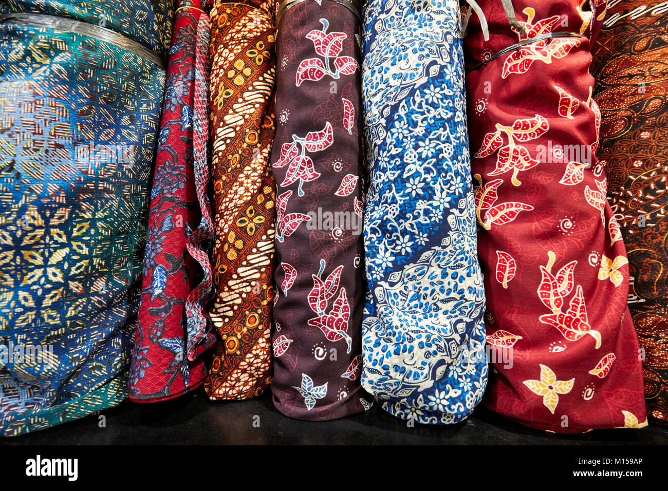 Selection of Javanese batik fabrics for sale in Hamzah Batik shop. Yogyakarta, Java, Indonesia. Stock Photo