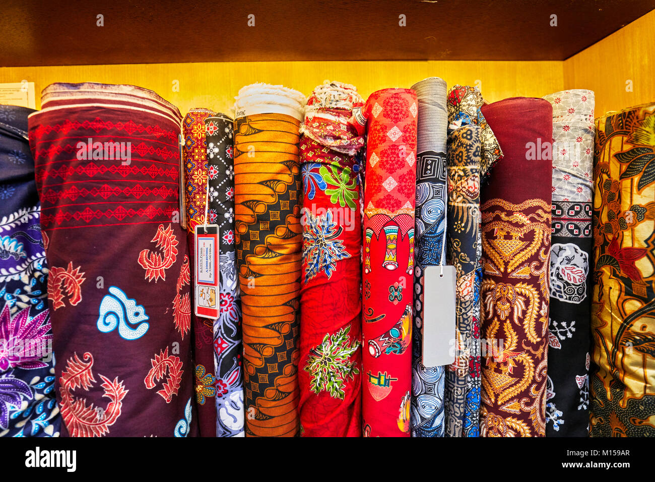 Selection of batik fabrics for sale in Hamzah Batik shop. Yogyakarta, Java, Indonesia. Stock Photo