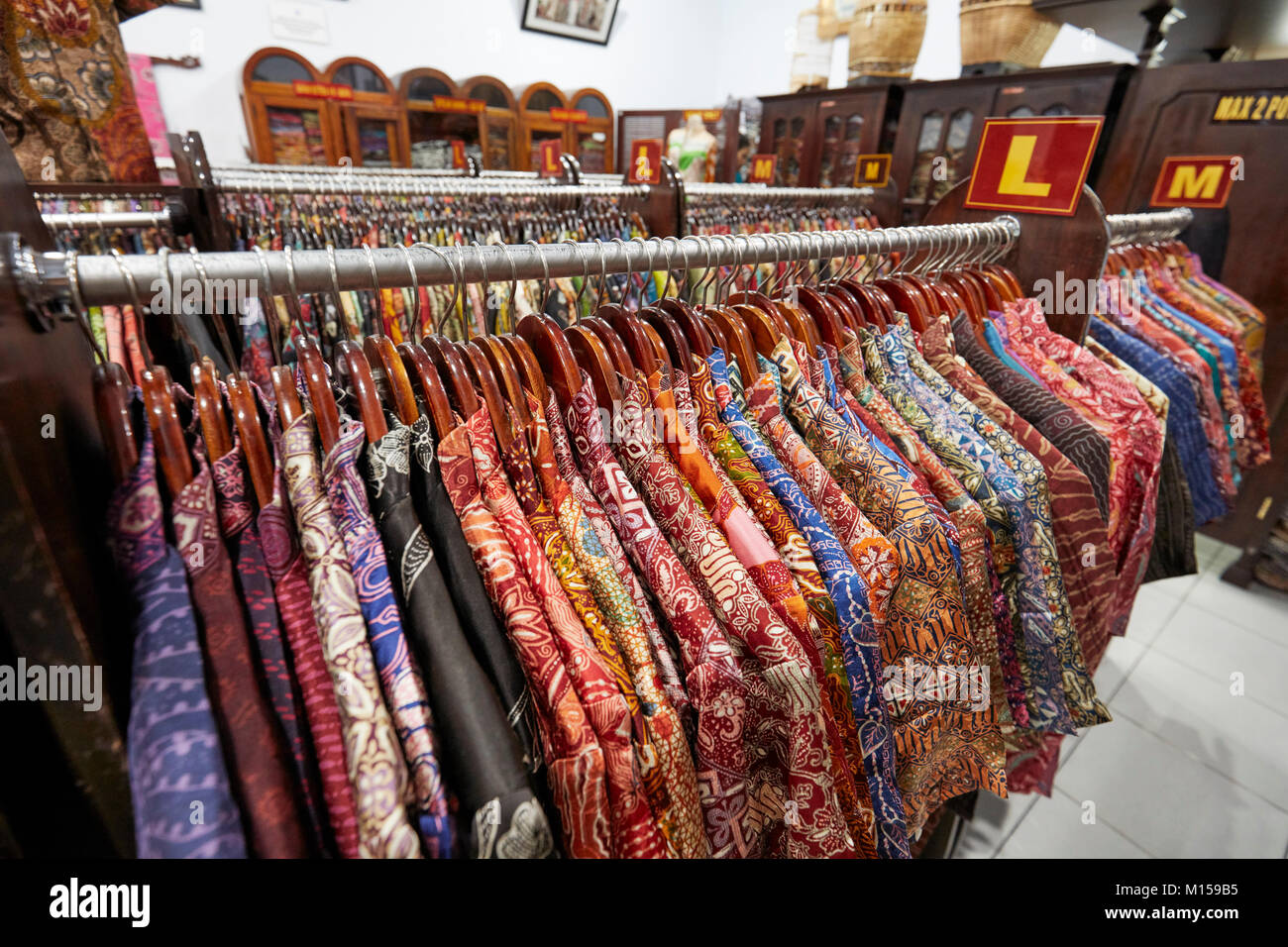 https://c8.alamy.com/comp/M159B5/colorful-silk-batik-shirts-on-a-rack-in-hamzah-batik-shop-yogyakarta-M159B5.jpg