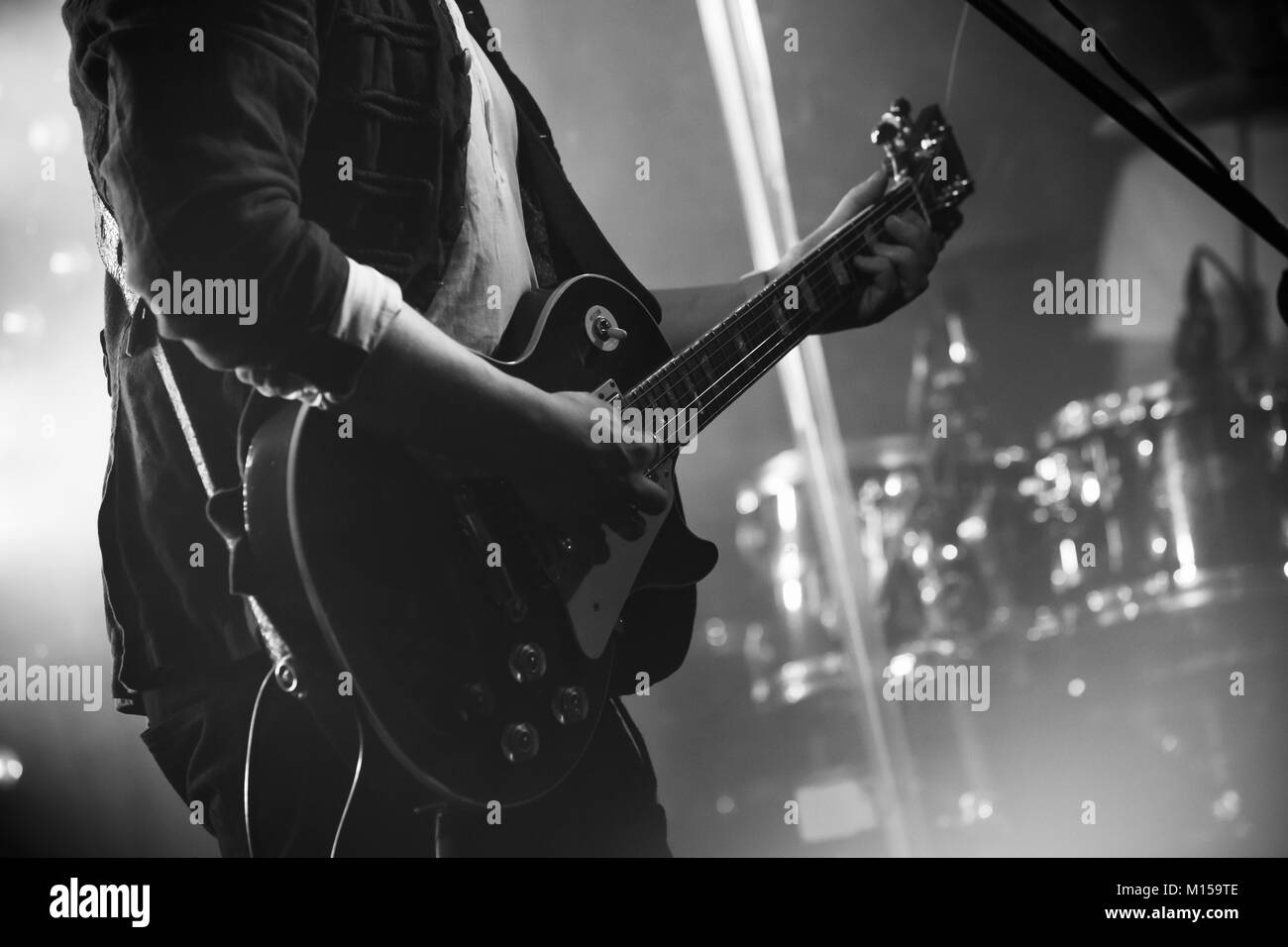 Rock and roll music black and white background, electric guitar player on a stage, photo with soft selective focus Stock Photo