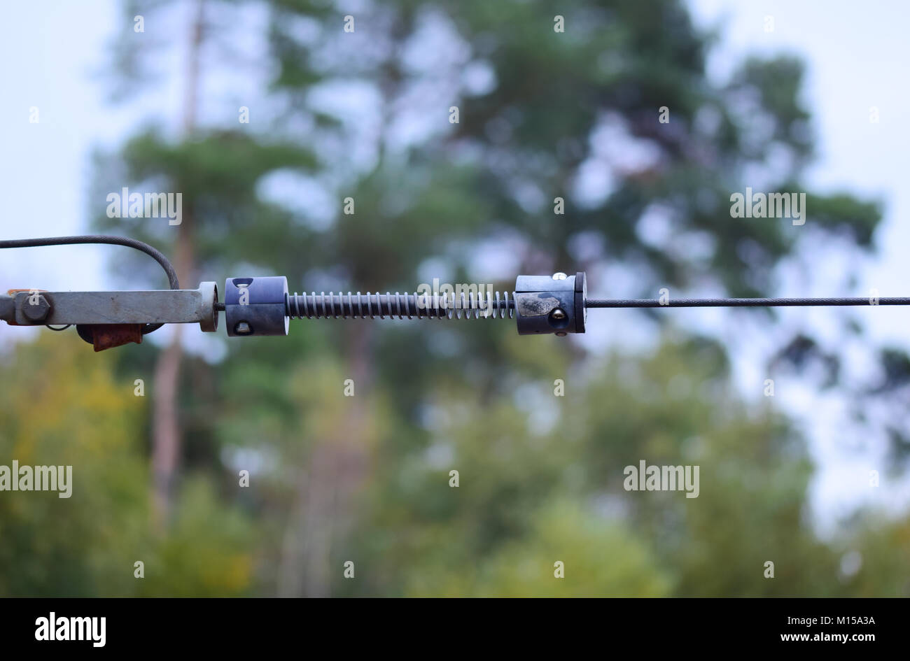 Spring loaded wire of a play park zip wire Stock Photo Alamy