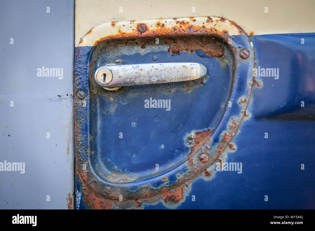 A rusty door handle mechanism on an old van Stock Photo Alamy