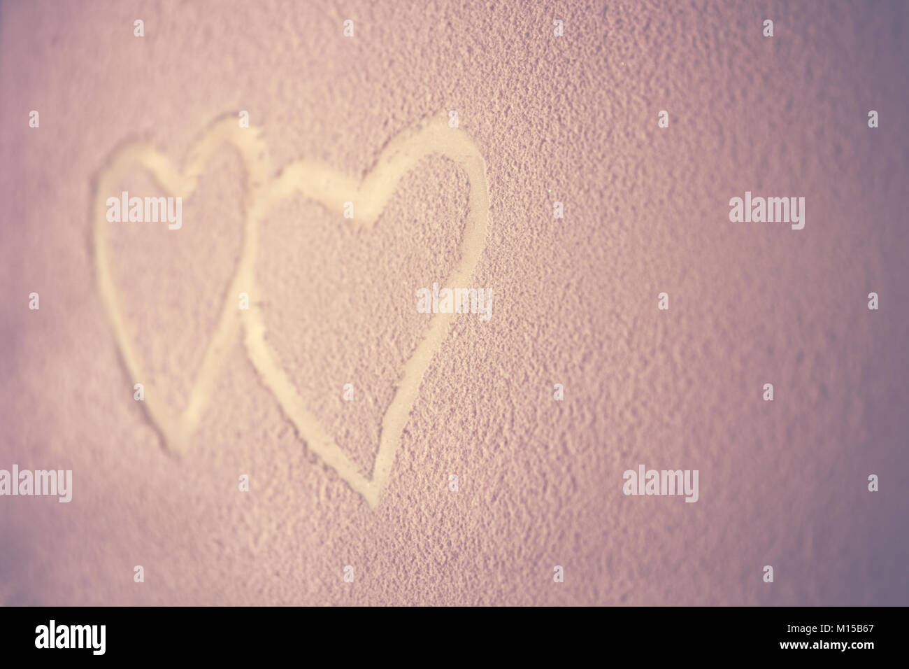 Two hearts, drawing on the snowy background, abstract pink background, heart to heart, romantic message for Valentines day, love concept Stock Photo
