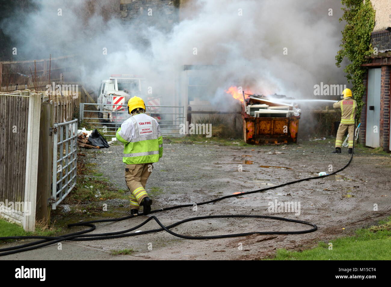 Fire Brigade attending a skip fire in North Wales Stock Photo - Alamy