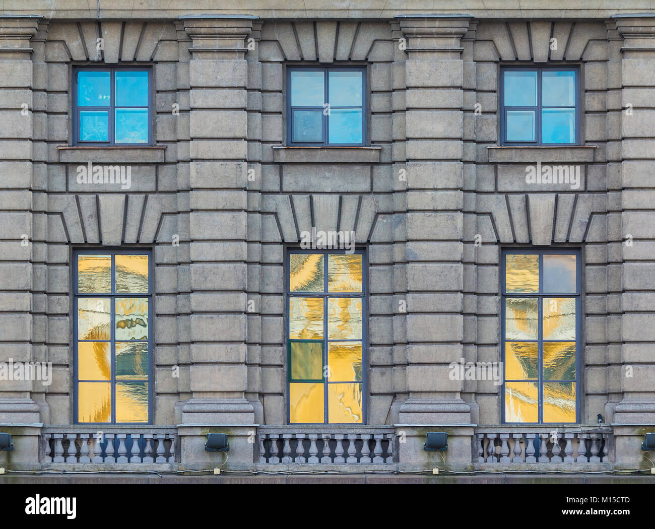 Several windows in a row on the facade of the urban historic building front view, Saint Petersburg, Russia Stock Photo