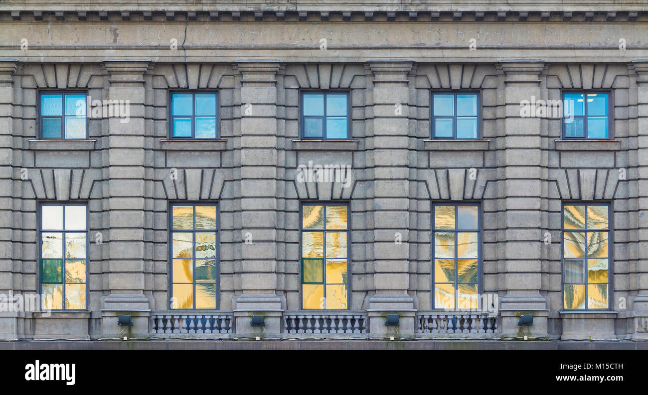 Several windows in a row on the facade of the urban historic building front view, Saint Petersburg, Russia Stock Photo