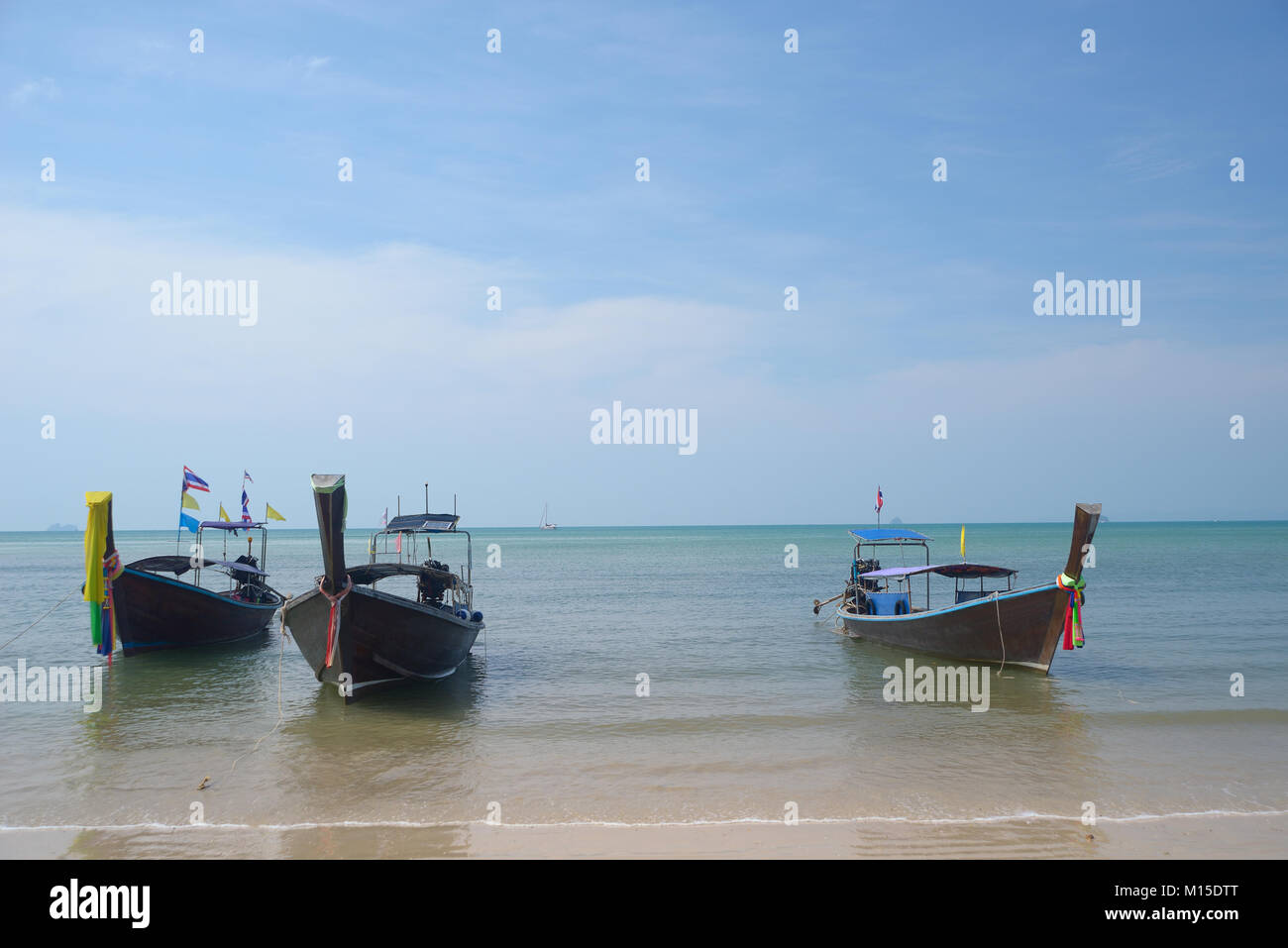 Three wooden boats moored at the beach Stock Photo - Alamy