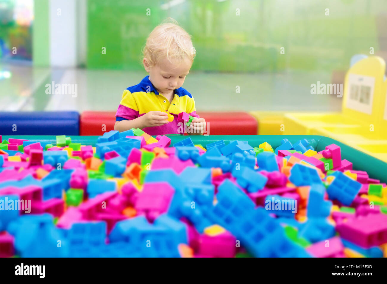 Child playing with colorful construction toy blocks. Educational toys ...