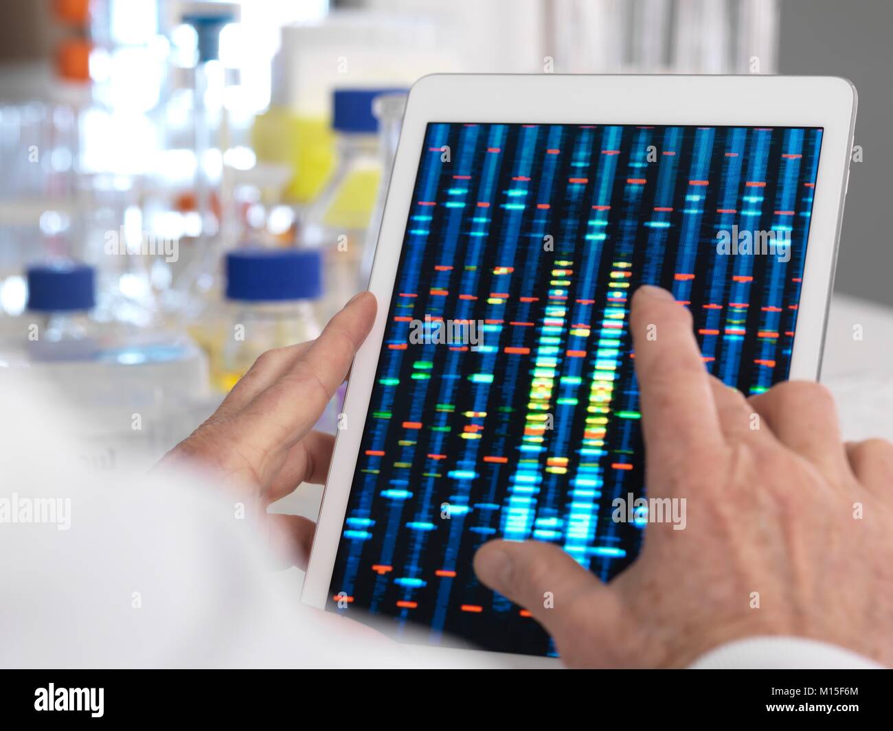 MODEL RELEASED. Scientist viewing results of a test on a